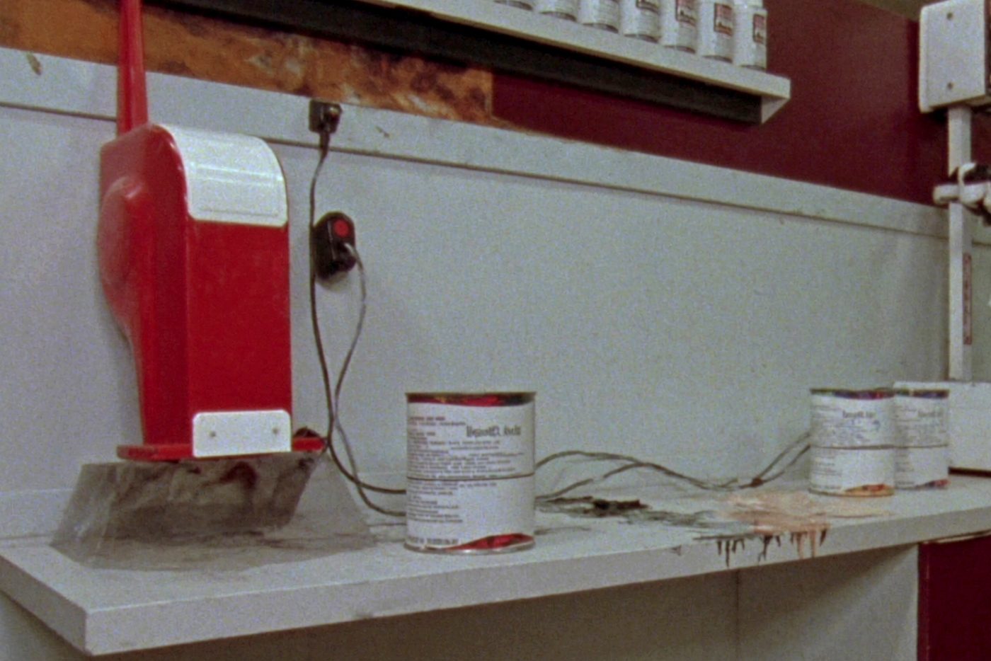 The paint counter, the shaker at one end and colour dried in runs down the front edge of the worktop.